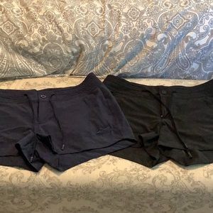2 pair Athleta shorts with button and drawstring colors are black and navy